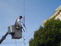 guy working on the guywires outside kates