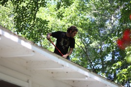 andrew cleaning tree litter off the roof